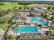 Aerial view of community pool area, tennis courts, and lush landscaping at 2586 Lancaster Ridge, Davenport, FL 33837