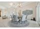 Dining area featuring a modern chandelier, seating for six, and large windows for natural light at 2586 Lancaster Ridge, Davenport, FL 33837
