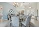 Bright dining room featuring a glass table, cushioned chairs, and stylish decor at 2586 Lancaster Ridge, Davenport, FL 33837