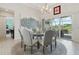 Well-lit dining area boasts a glass table, rug, and large sliding doors leading to outdoor space at 2586 Lancaster Ridge, Davenport, FL 33837