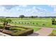 Scenic driving range view, featuring well-maintained greens and manicured landscaping at 2586 Lancaster Ridge, Davenport, FL 33837