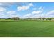 Lush golf course showcasing its smooth green and beautiful landscaping under a bright sky at 2586 Lancaster Ridge, Davenport, FL 33837