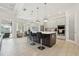 Bright, open kitchen with a large center island, stainless appliances, and bar stool seating, adjacent to living area at 2586 Lancaster Ridge, Davenport, FL 33837