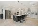 Modern kitchen with a large center island, stainless steel appliances, ample cabinetry, and bar stool seating at 2586 Lancaster Ridge, Davenport, FL 33837