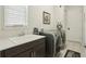 Modern laundry room featuring washer, dryer, sink, and ample counter space at 2586 Lancaster Ridge, Davenport, FL 33837