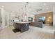 Spacious open-concept kitchen and living area with a large island, stone accent wall, and modern finishes at 2586 Lancaster Ridge, Davenport, FL 33837