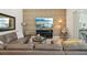 Inviting living room featuring a stylish stone accent wall, comfortable leather sofa, and a large entertainment center at 2586 Lancaster Ridge, Davenport, FL 33837