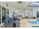 Relaxing outdoor living space with comfortable seating, an outdoor kitchen, and a view of the sparkling pool at 2586 Lancaster Ridge, Davenport, FL 33837