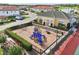 Community playground area with colorful equipment, nestled near a clubhouse and residential area at 2586 Lancaster Ridge, Davenport, FL 33837