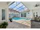 A serene outdoor oasis showcasing a sparkling pool, spa, and a fully screened-in enclosure for year-round enjoyment at 2586 Lancaster Ridge, Davenport, FL 33837