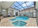 Sparkling swimming pool with a built-in spa, tiled deck, and a screen enclosure for optimal outdoor enjoyment at 2586 Lancaster Ridge, Davenport, FL 33837