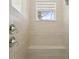 Modern shower with a built-in seat and dual shower heads, complemented by neutral tiling at 2586 Lancaster Ridge, Davenport, FL 33837