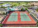 Aerial view of tennis courts, pool and clubhouse at a community center with manicured lawns and lush landscaping at 2586 Lancaster Ridge, Davenport, FL 33837