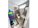 Modest bathroom featuring tile flooring, pedestal sink, and toilet under a glass block window at 2716 Upsandown St, Orlando, FL 32837