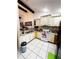 Well-lit kitchen features white cabinetry, a stainless steel refrigerator, and tile flooring for easy maintenance at 2716 Upsandown St, Orlando, FL 32837