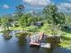 Aerial view of the property featuring a lake, dock, gazebo, and lush green lawns at 277 Sunrise Pt, Lake Mary, FL 32746