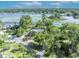 Aerial view of the home surrounded by lush greenery and a serene lake at 277 Sunrise Pt, Lake Mary, FL 32746