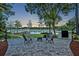 Enjoy the outdoors with this backyard featuring a brick patio, fire pit, dock and lake views at 277 Sunrise Pt, Lake Mary, FL 32746