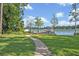 Pathway leading to a dock and gazebo on the lake with lush green lawn at 277 Sunrise Pt, Lake Mary, FL 32746