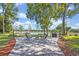 This backyard features a brick patio, fire pit, outdoor grilling area, and lake views at 277 Sunrise Pt, Lake Mary, FL 32746