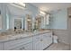 A clean bathroom featuring double sinks with white cabinets and marble countertops at 277 Sunrise Pt, Lake Mary, FL 32746