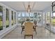 Bright dining room with natural light and lake view, featuring a wood table with seating for six at 277 Sunrise Pt, Lake Mary, FL 32746