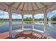 Lakeside gazebo with seating provides a serene spot to enjoy the water views at 277 Sunrise Pt, Lake Mary, FL 32746