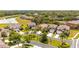 An aerial view of the neighborhood showcases lush landscaping, well-maintained homes, and a tranquil pond at 2805 Lido Key Ct, Kissimmee, FL 34747
