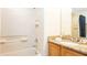 Bathroom features a bathtub and shower combination with wood cabinets and a granite countertop at 2805 Lido Key Ct, Kissimmee, FL 34747