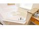 Corner soaking tub with granite accents, offering a relaxing retreat at 2805 Lido Key Ct, Kissimmee, FL 34747