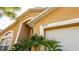 Inviting mustard-colored home exterior featuring a white garage door and the house number 2805 at 2805 Lido Key Ct, Kissimmee, FL 34747