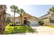Inviting single-Gathering home with lush landscaping, a two-car garage, and an arched entryway at 2805 Lido Key Ct, Kissimmee, FL 34747