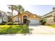 Inviting single-Gathering home with lush landscaping, a two-car garage, and an arched entryway at 2805 Lido Key Ct, Kissimmee, FL 34747