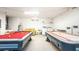 Spacious game room offering a pool table, air hockey, washer, dryer and utility sink at 2805 Lido Key Ct, Kissimmee, FL 34747