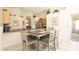 Well-lit kitchen with bar seating and tile flooring, open to living and dining area at 2805 Lido Key Ct, Kissimmee, FL 34747