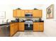 Kitchen features stainless steel appliances, cabinetry, granite countertops, and tile flooring at 2805 Lido Key Ct, Kissimmee, FL 34747