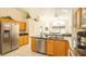 Spacious kitchen with stainless steel refrigerator and open layout to dining and living area at 2805 Lido Key Ct, Kissimmee, FL 34747