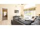 Cozy living room with a sliding glass door view to the pool area, tile flooring, and modern furnishings at 2805 Lido Key Ct, Kissimmee, FL 34747
