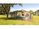 Exterior backyard showing a pool and a screened in patio with a grassy lawn at 2805 Lido Key Ct, Kissimmee, FL 34747