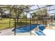 Backyard with an enclosed pool, green grass, and mature trees at 2805 Lido Key Ct, Kissimmee, FL 34747