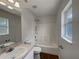 Clean bathroom with tiled shower, white sink, and window at 3090 Yorkshire Dr, Deltona, FL 32738