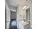 Bathroom with a sleek single sink vanity and ample lighting at 3090 Yorkshire Dr, Deltona, FL 32738