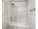 Clean bathtub and shower combo featuring a white tile surround at 3090 Yorkshire Dr, Deltona, FL 32738