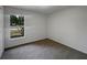 Clean, simple bedroom with carpet flooring and large window at 3090 Yorkshire Dr, Deltona, FL 32738
