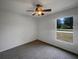Simple bedroom with a ceiling fan and natural light from a window at 3090 Yorkshire Dr, Deltona, FL 32738
