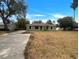 Single-story home with a well-manicured lawn and a concrete driveway at 3090 Yorkshire Dr, Deltona, FL 32738