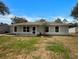 Charming single story home with well-maintained lawn, neutral color, and inviting front entrance at 3090 Yorkshire Dr, Deltona, FL 32738