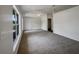Large carpeted living room with large windows, allowing lots of natural light at 3090 Yorkshire Dr, Deltona, FL 32738