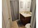 Bathroom features a shower with curtain, vanity, mirror, and tile floor at 3265 Stratton Cir, Kissimmee, FL 34744