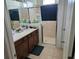 Bathroom featuring double sinks and glass-enclosed shower at 3265 Stratton Cir, Kissimmee, FL 34744